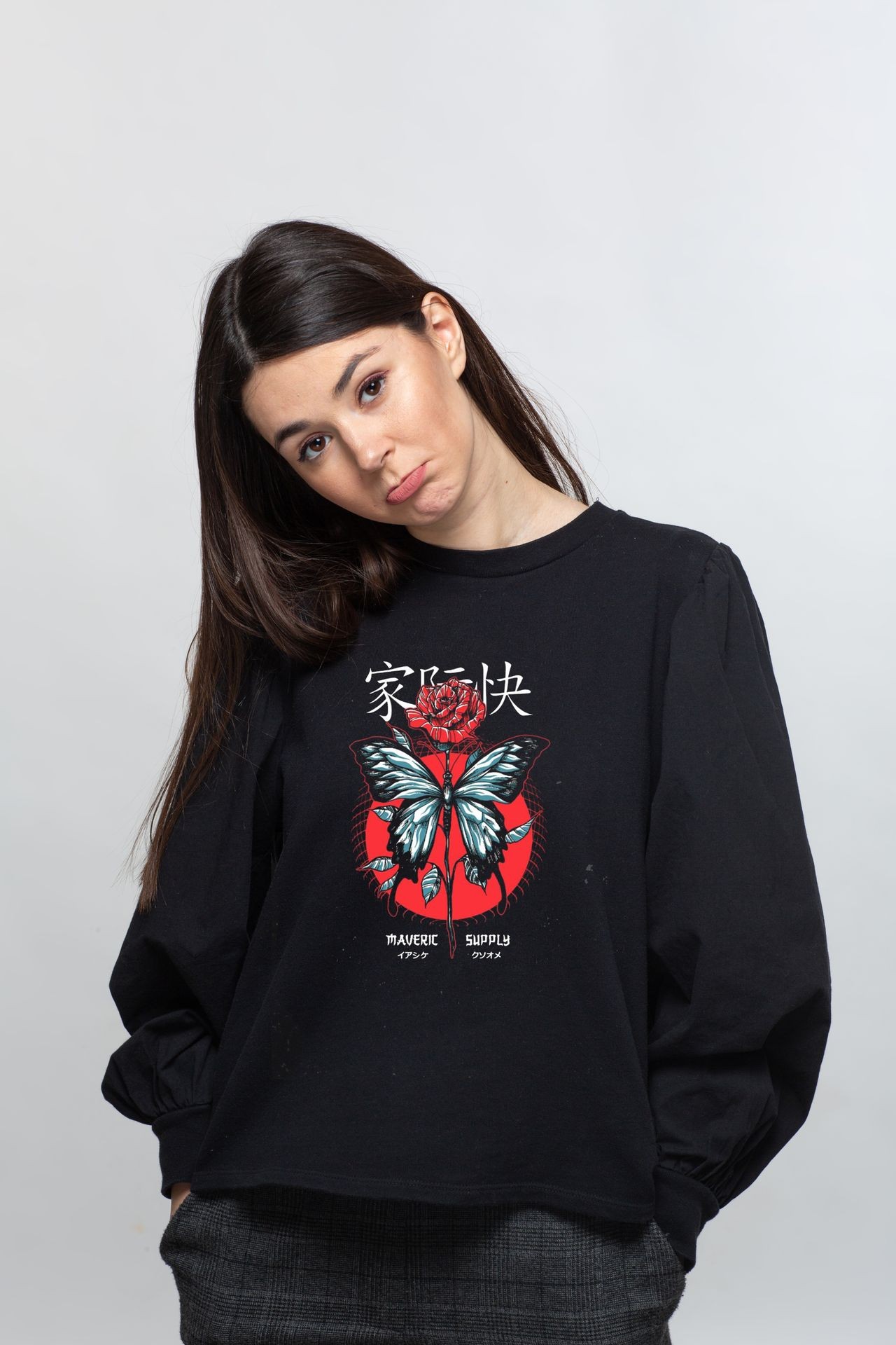 Person wearing a black sweatshirt with a butterfly and rose design, featuring text in Japanese and English.